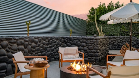 Gather around the fire pit as dusk settles over the desert