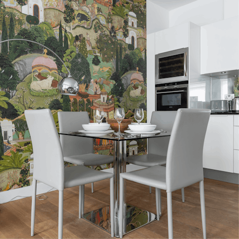 Dine in front of the artsy mural wallpaper