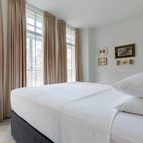 Enjoy natural light streaming into the bedroom through three huge windows