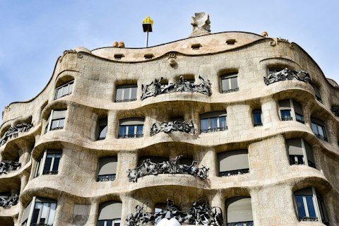 Marvel at Gaudí's extraordinary Casa Milà, a sixteen-minute walk