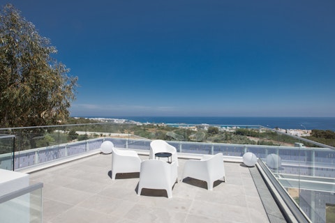 Settle into rooftop seating with sweeping views across Protaras coast