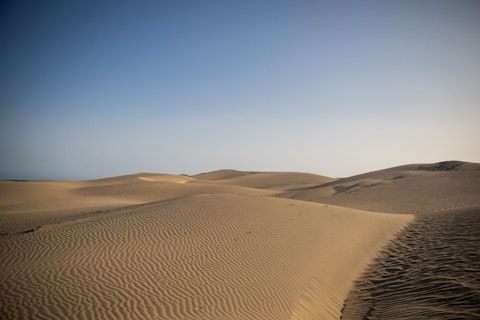 Explore the iconic Maspalomas Dunes, not far by car