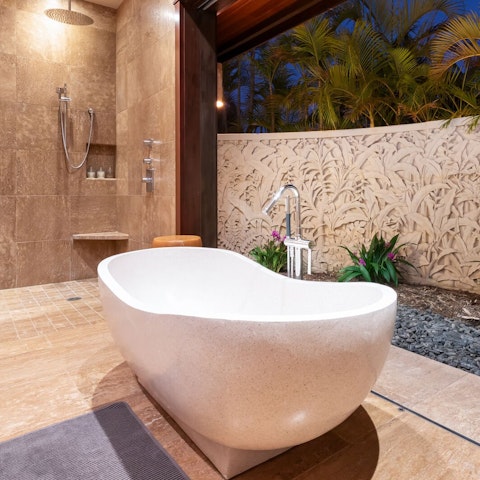 Soak in the freestanding tub as a tropical breeze drifts through the bathroom