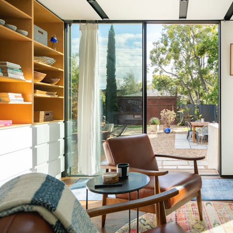 Choose a book and relax in the living room with its view over the patio