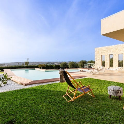 Lounge by the pool with a drink and watch the sunset