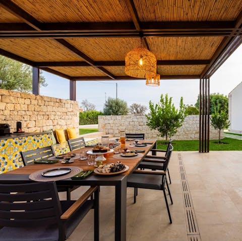 Dine alfresco at the large outdoor dining table