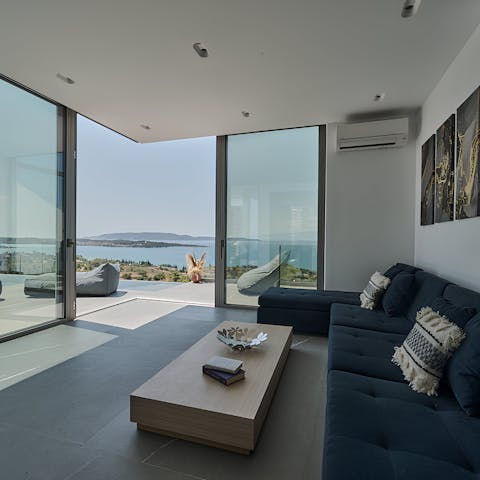 Admire the Aegean Sea views from the large windows