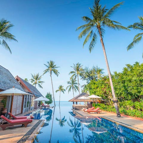 Lounge by the luxurious pool and enjoy the stunning sea views beyond