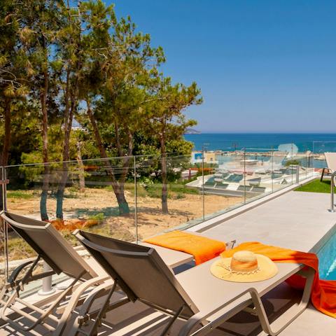 Sunbath on the day beds while taking in the stunning seascape