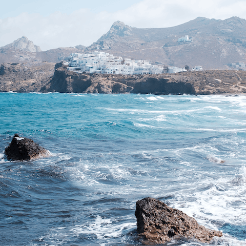 Spend warm afternoons relaxing on Agios Prokopios Beach, a kilometre away