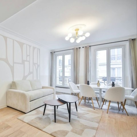Gather in a light-filled living room with classic Haussmann details