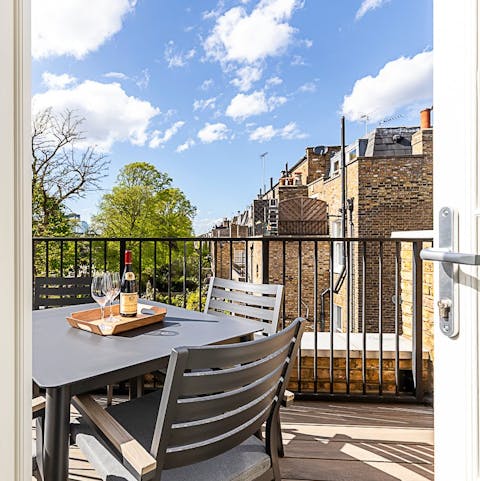 Watch the sun set over Chelsea on the balcony