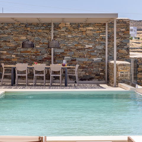 Float in the private pool under clear blue skies