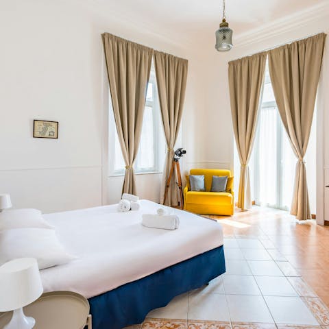Wake up to soft morning light in one of the apartment’s airy bedrooms — ideal for slow starts before a day of exploring Naples