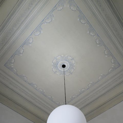 Admire original features like preserved ceiling paintings from 1838