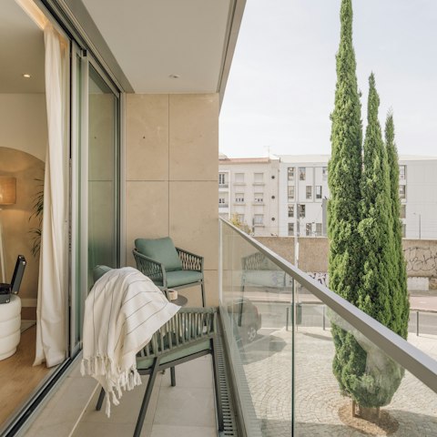 Unwind on the balcony after sightseeing, a glass of wine in hand