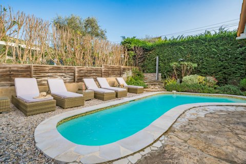 Drift into relaxation on cushioned loungers beside the private pool