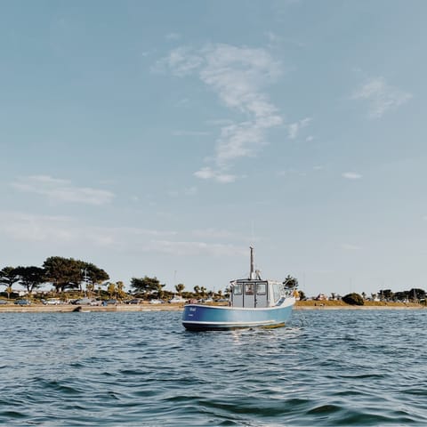 Spend the day at Sandbanks Beach, a thirteen-minute drive away