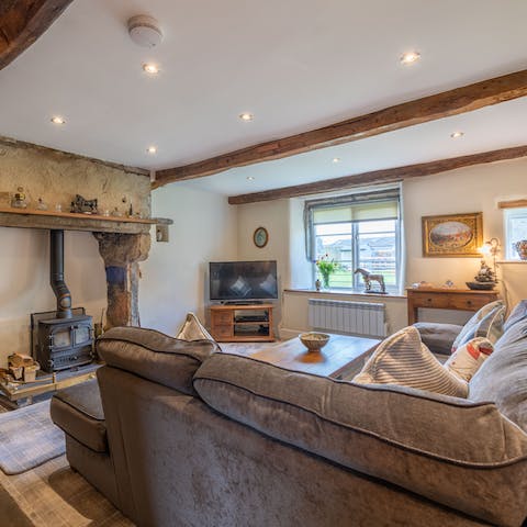 Peer out at the lambs on the village green through the lounge windows