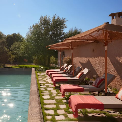 Lie back under the shade by the pool