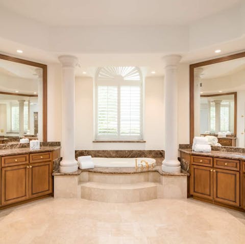 Pamper yourselves in the enormous marble bath tub