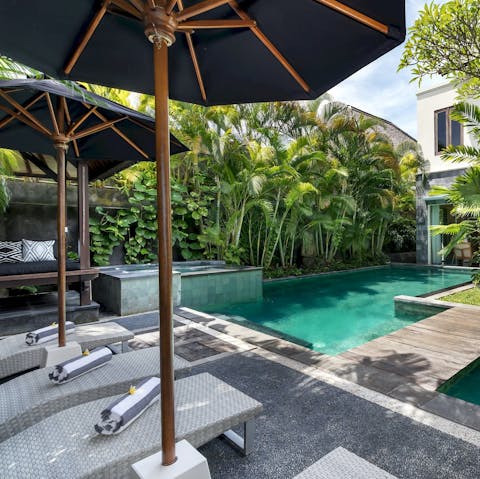 Sunbathe poolside, drink in hand