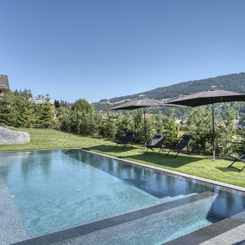 Slip into the outdoor swimming pool on sunny summer days