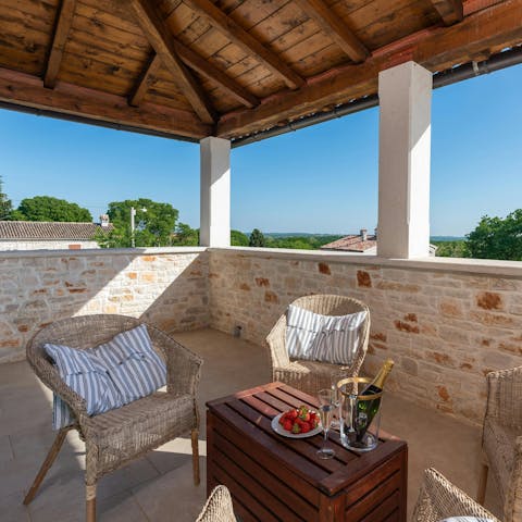 Toast the day with drinks on the balcony and sea views