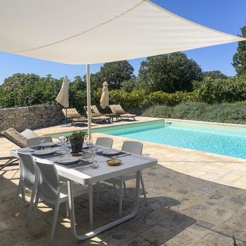 Drink or dine alfresco on the covered poolside terrace surrounded by lush greenery