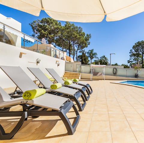 Lie back on the poolside loungers in the shade of the parasol and work on that perfect bronze tan