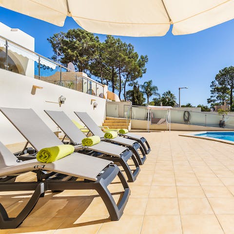 Lie back on the poolside loungers in the shade of the parasol and work on that perfect bronze tan