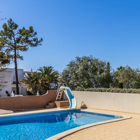 Relax in the calm waters of the private pool or go down the slide for some summer fun