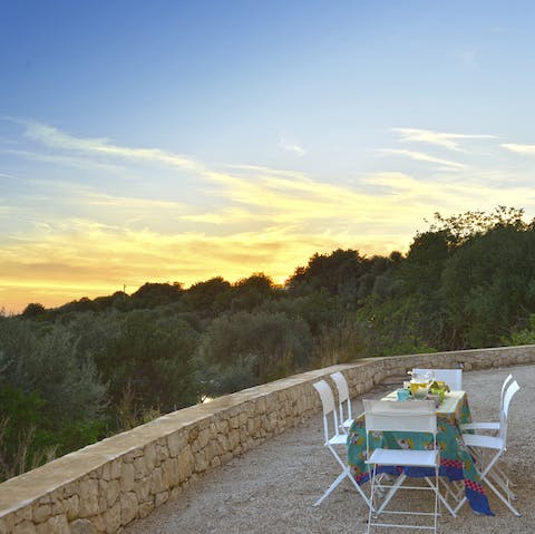 Dine alfresco while the sun sets into the lush greenery