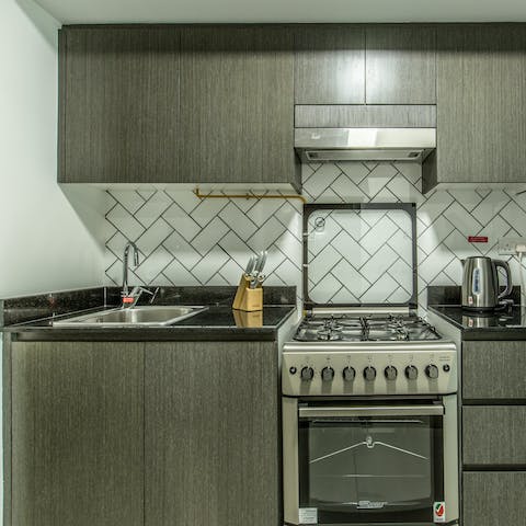 Whip up light bites and late night snacks in the sleek kitchen