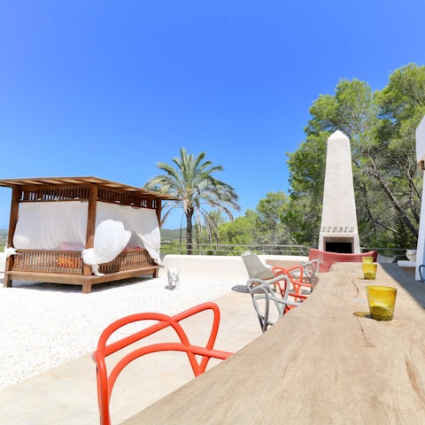 Climb up to the rooftop terrace and read in the cabana day bed