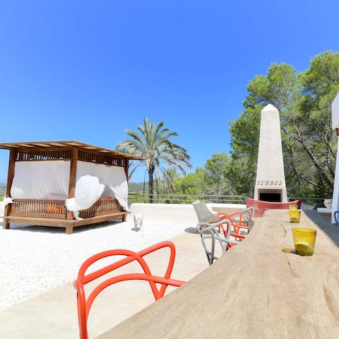 Climb up to the rooftop terrace and read in the cabana day bed