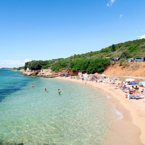 Relax on the white sandy beach just outside your door