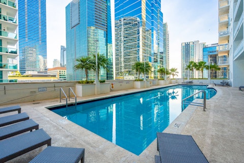 Swim laps in the communal pool overlooking glittering skyscrapers