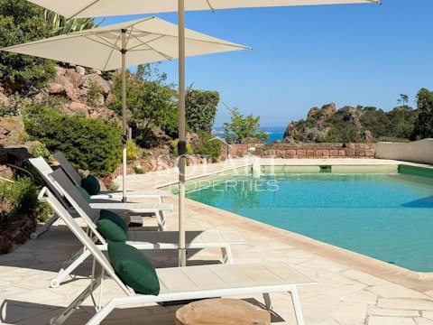 Stretch out beside the pool as the sea glitters beyond