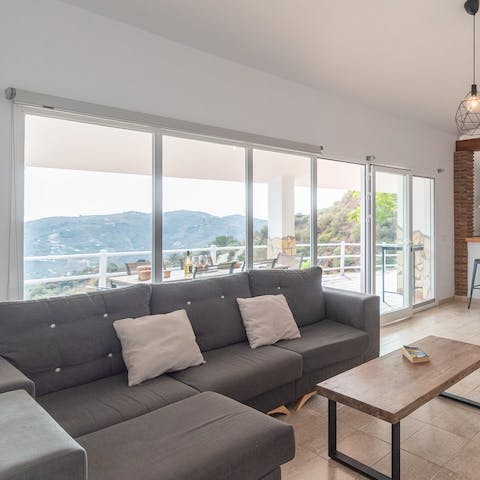Read in the light of the wall-to-wall windows as you make yourself comfortable on the sofa