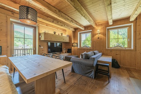 Unwind in a warm, wood-clad living space with mountain views