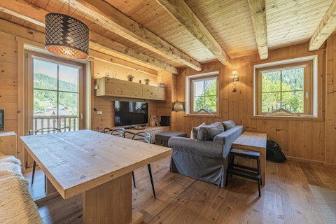 Unwind in a warm, wood-clad living space with mountain views