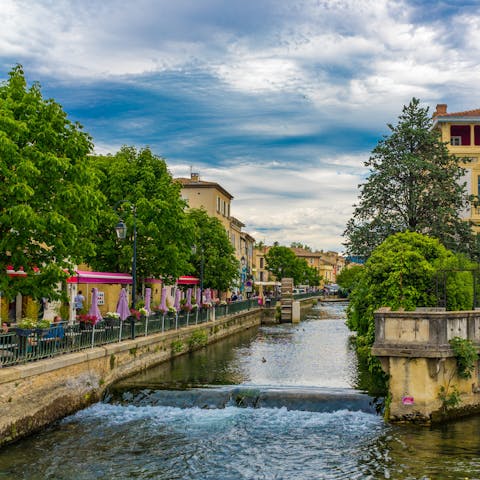 Treat yourself to a coffee at one of L'Isle-sur-Sorgue's charming riverside cafés
