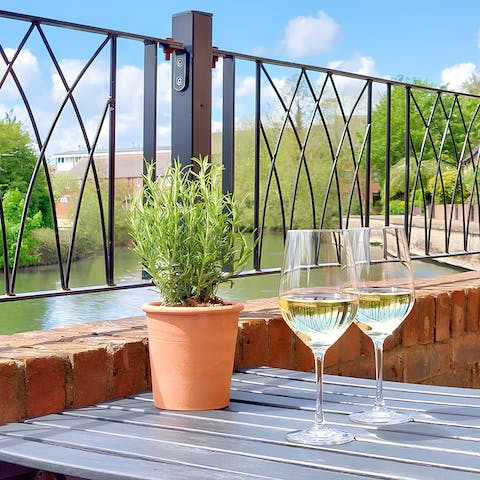 Sip sundowners on the patio, overlooking the River Thames