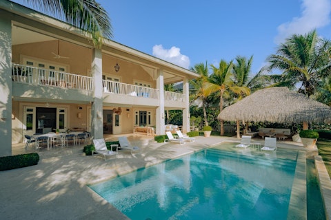Swim laps then cool down beneath a thatched palapa
