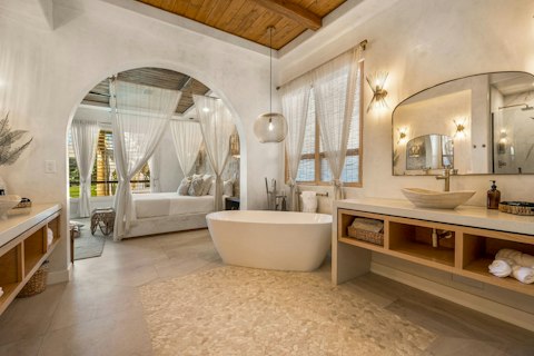 Step straight from the bedroom into this serene bathing space