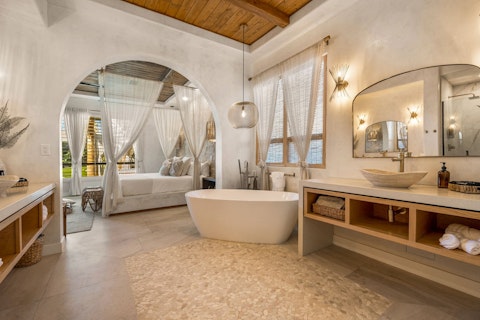 Step straight from the bedroom into this serene bathing space