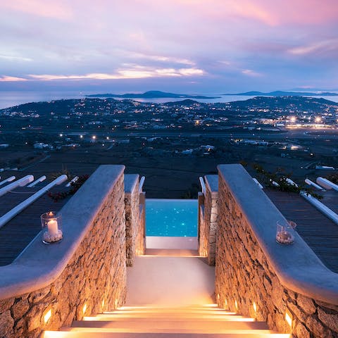 Look out over the shimmering lights of Mykonos Old Town from the terrace