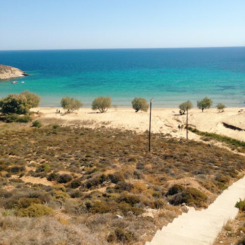 Take the seven-minute stroll to Fourka beach and sink your feet into the turquoise waters