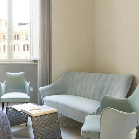 Open a bottle of Chianti and get comfortable on the pastel blue sofa